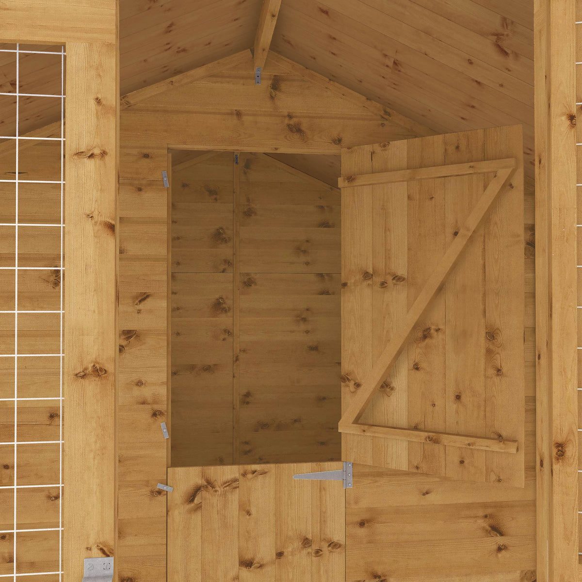 Interior of wooden dog kennel with internal access door