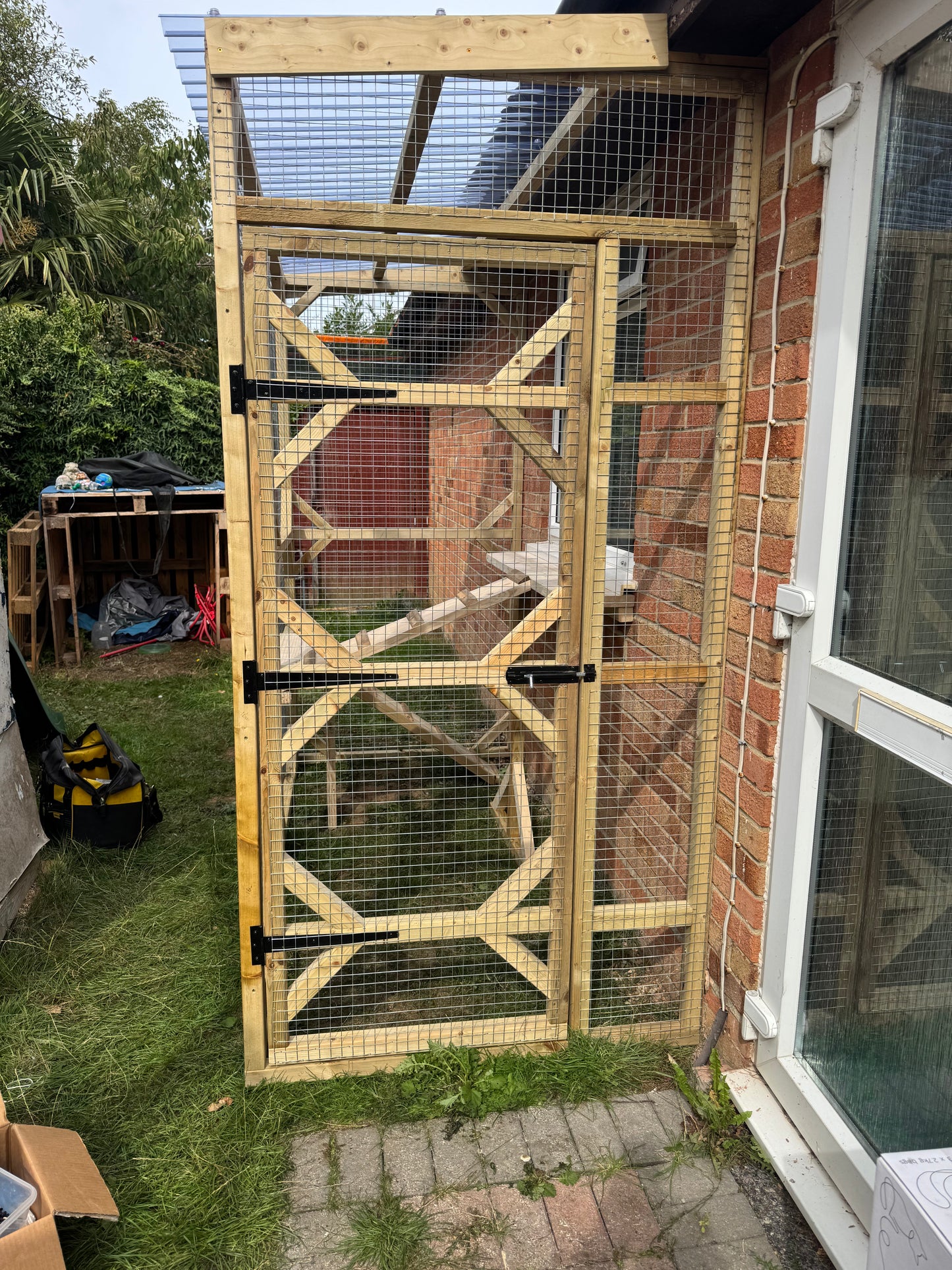 Finished timber catio attached to a brick house for three cats