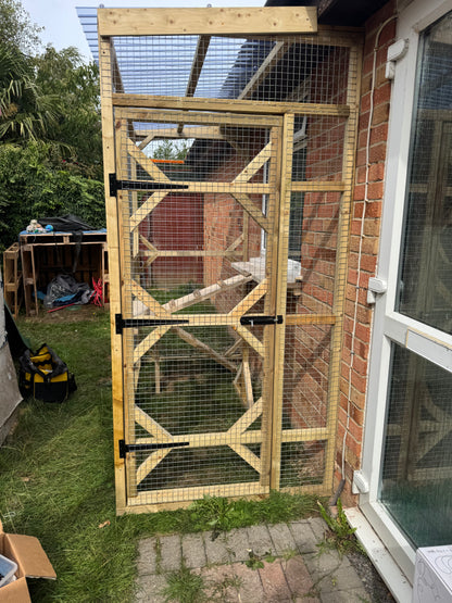 Finished timber catio attached to a brick house for three cats